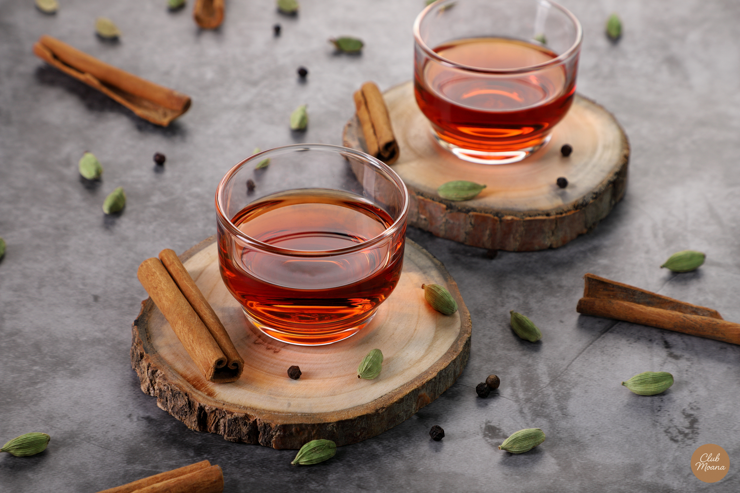 A refreshing glass of water and cinnamon sticks on a rustic table