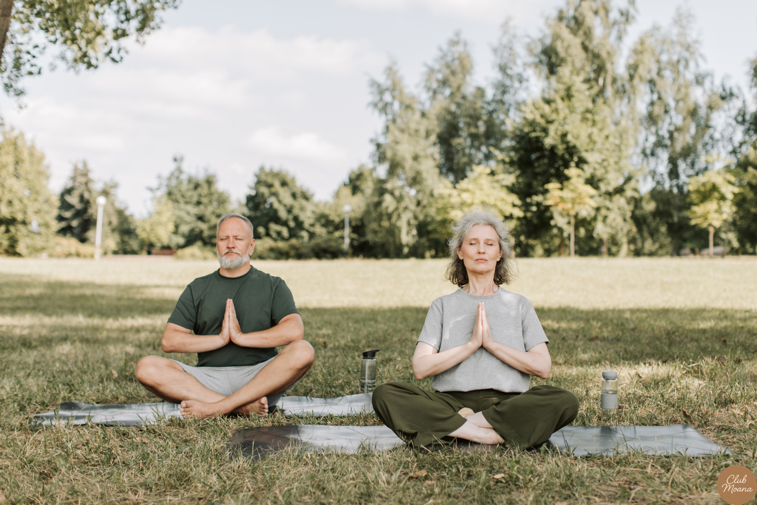 A smiling, confident man (40s–50s) doing yoga, hiking, or relaxing in nature.