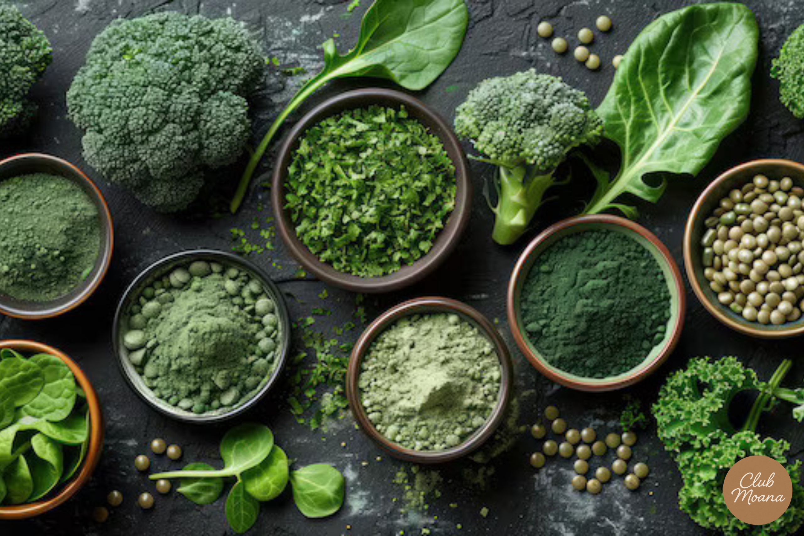 Flat-lay photo of different green superfoods like kale, spirulina, broccoli, spinach
