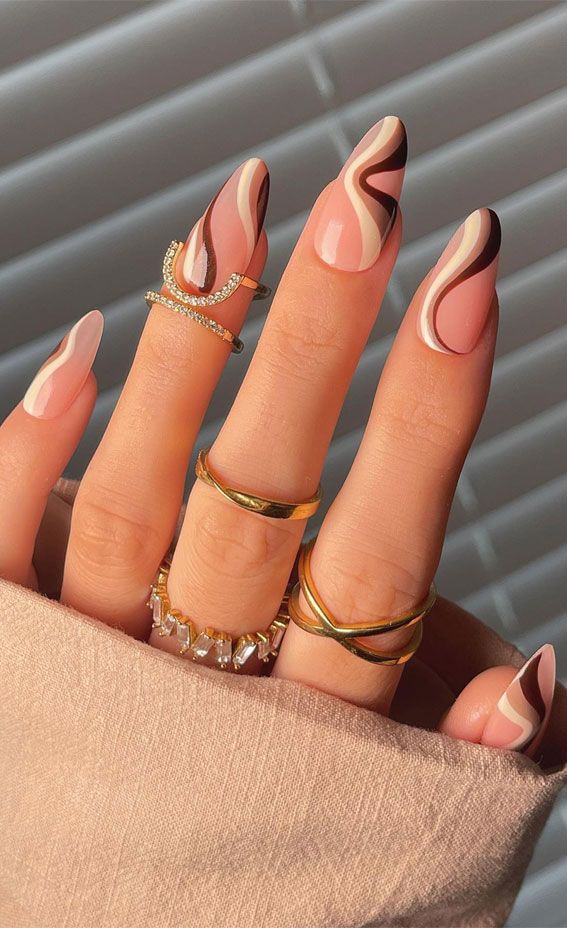 Mixed brown and nude nails with swirl designs