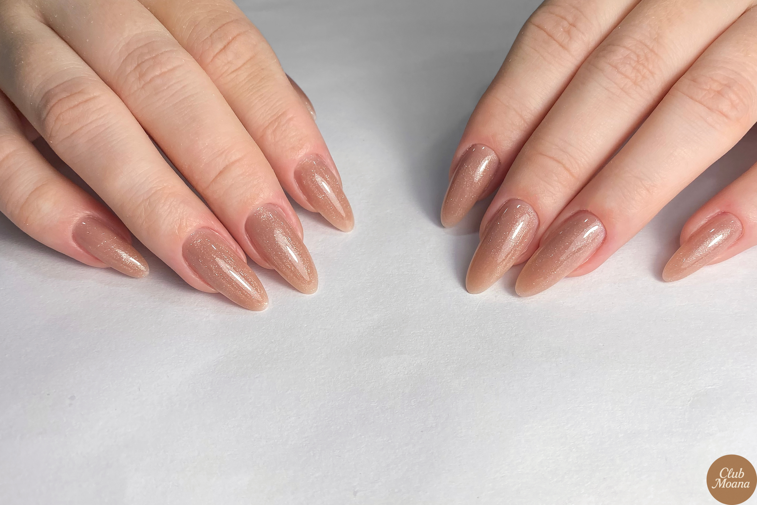 Rose gold chrome nails holding a gift box