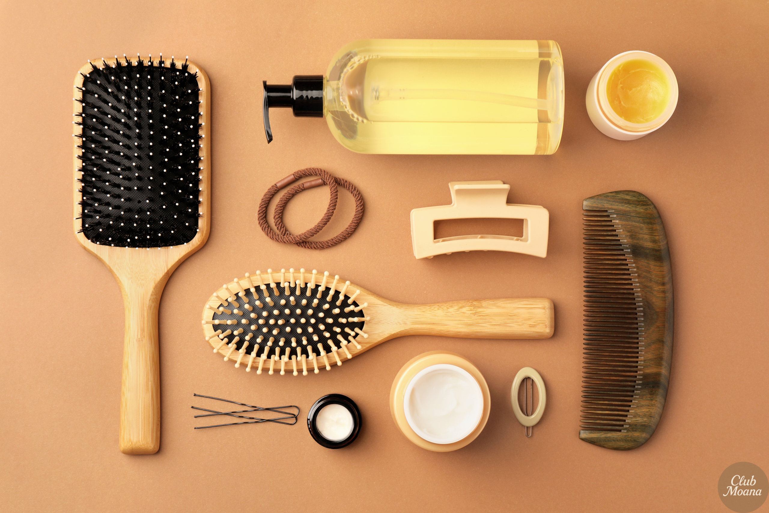 Flat lay of natural oils and a wooden comb