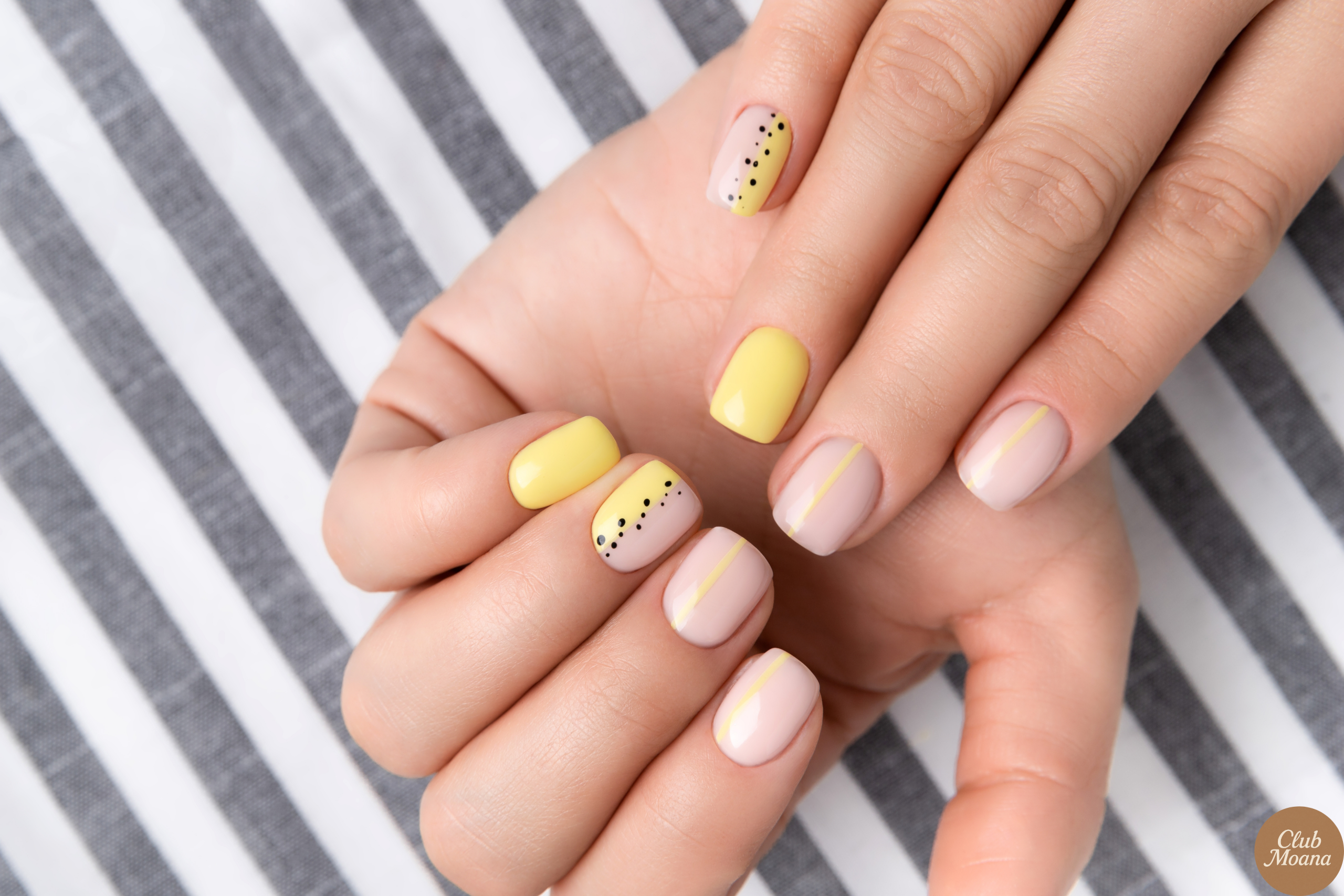 Glossy summer nails catching golden hour light near the beach