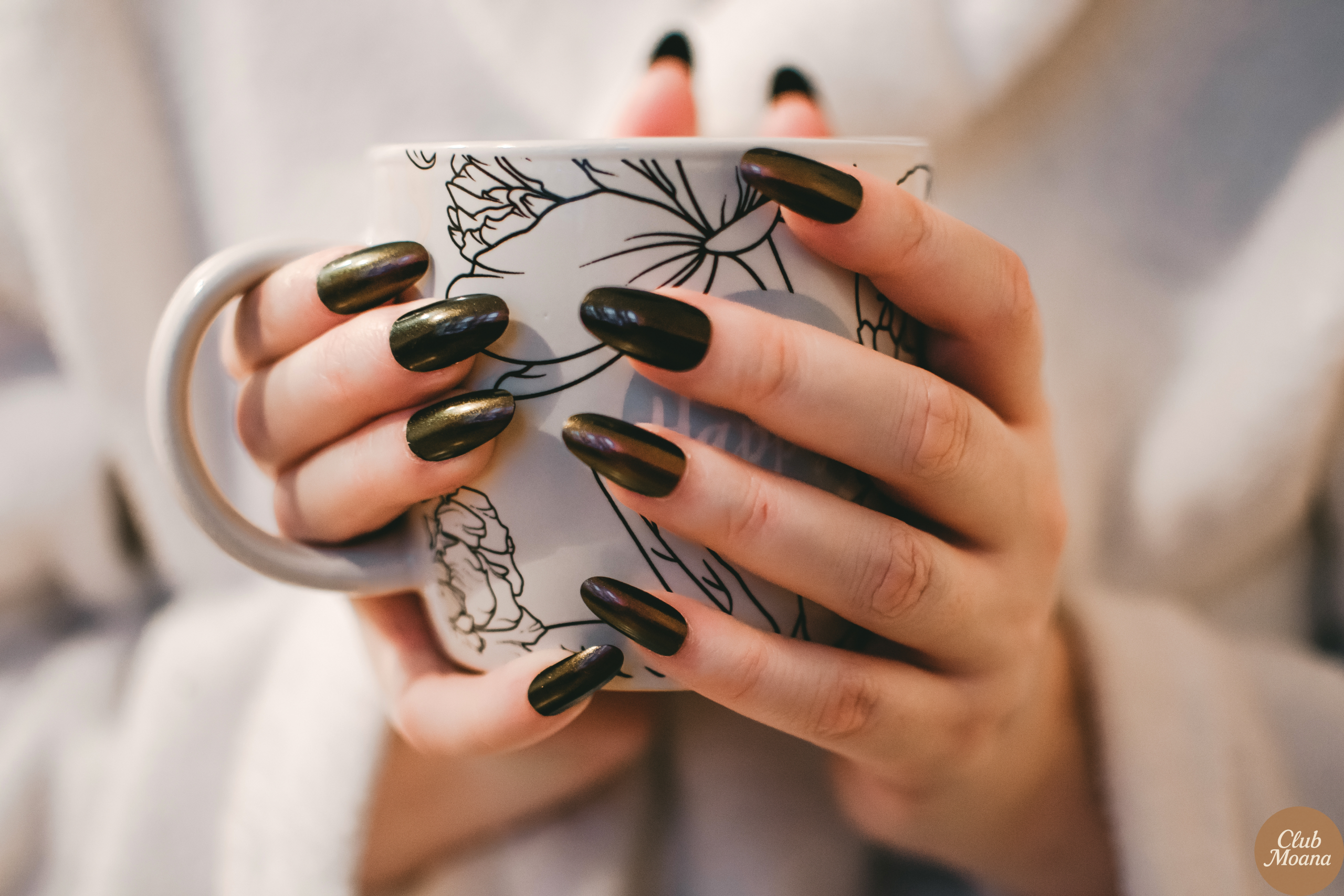 Hands showcasing multiple timeless designs, smiling with a tea cup