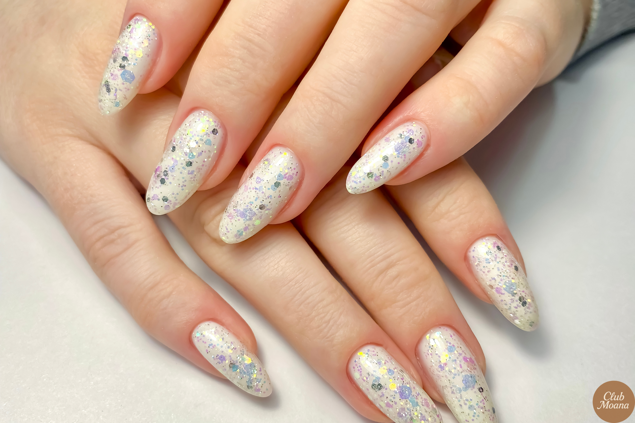 Mirror chrome nails reflecting light in rose gold and violet hues