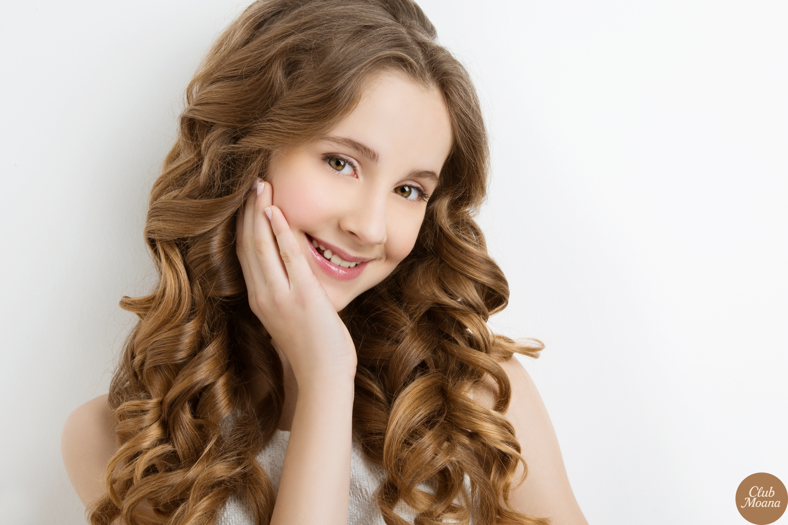 Smiling woman with long shiny half-up hair outdoors