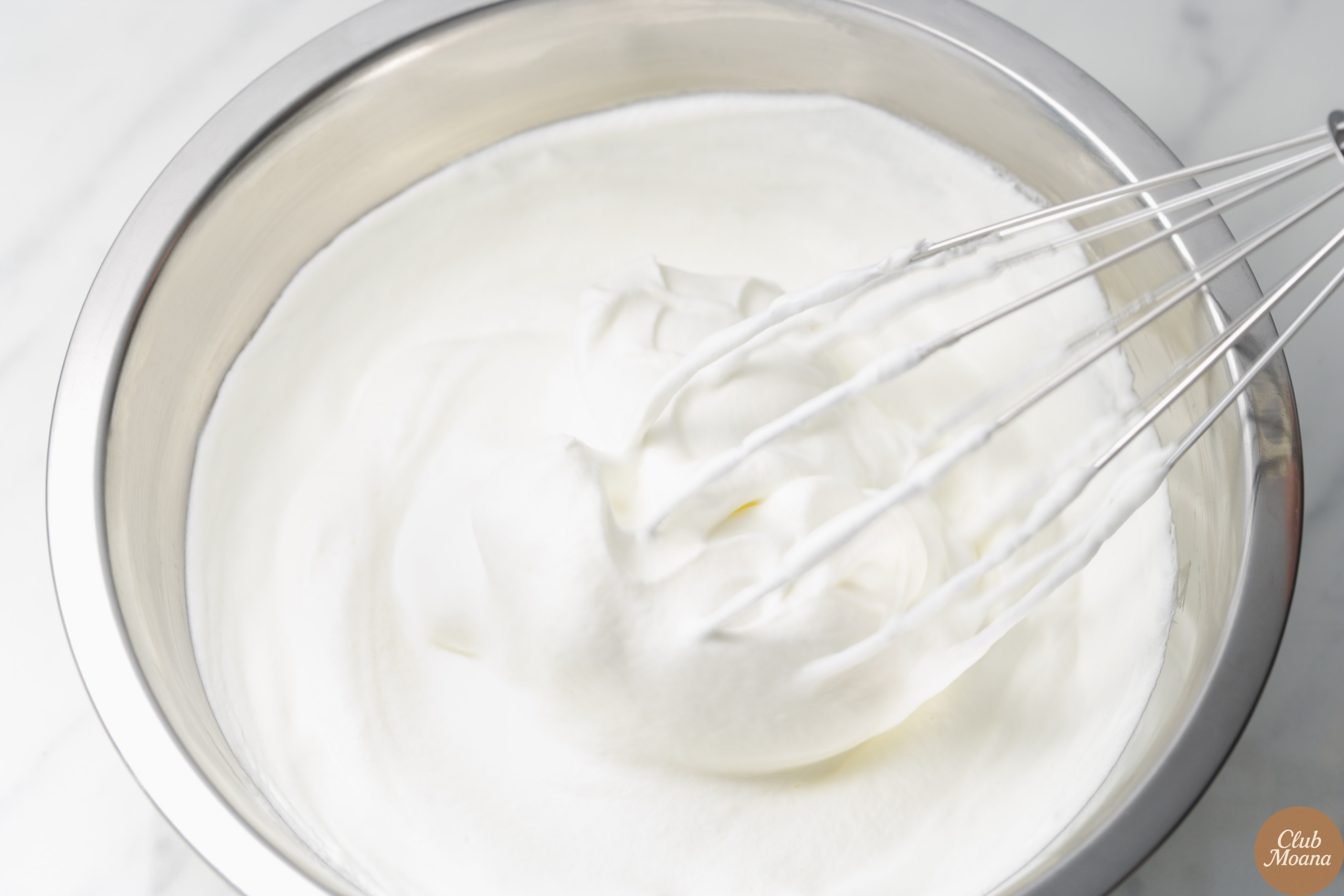 Stirring cream and cheese into the skillet